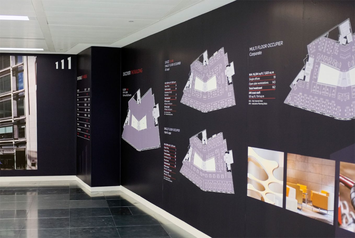 Wall display featuring architectural models and informational graphics for the a11 project.