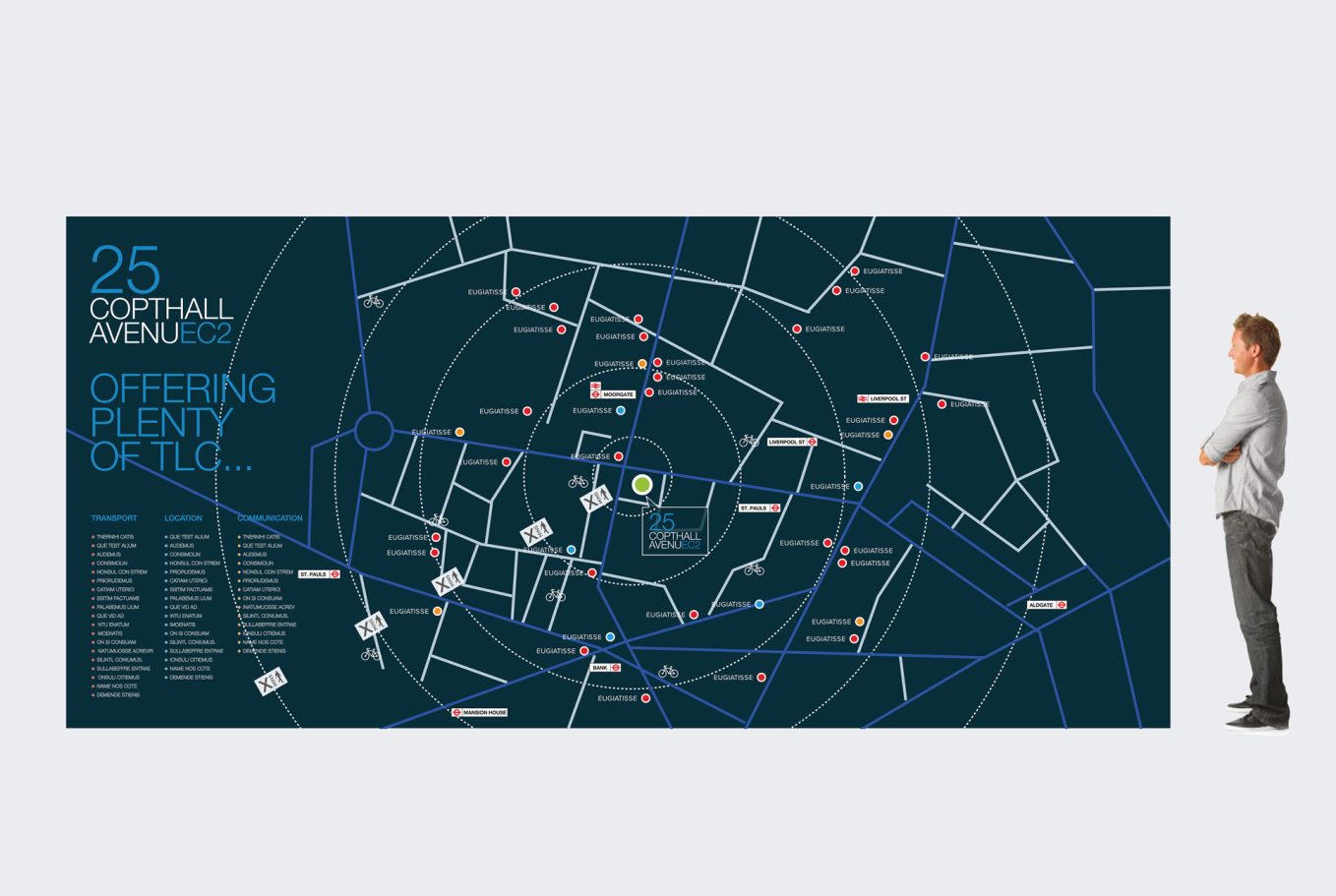 Map displaying street names and locations in a city, with a person standing beside it.