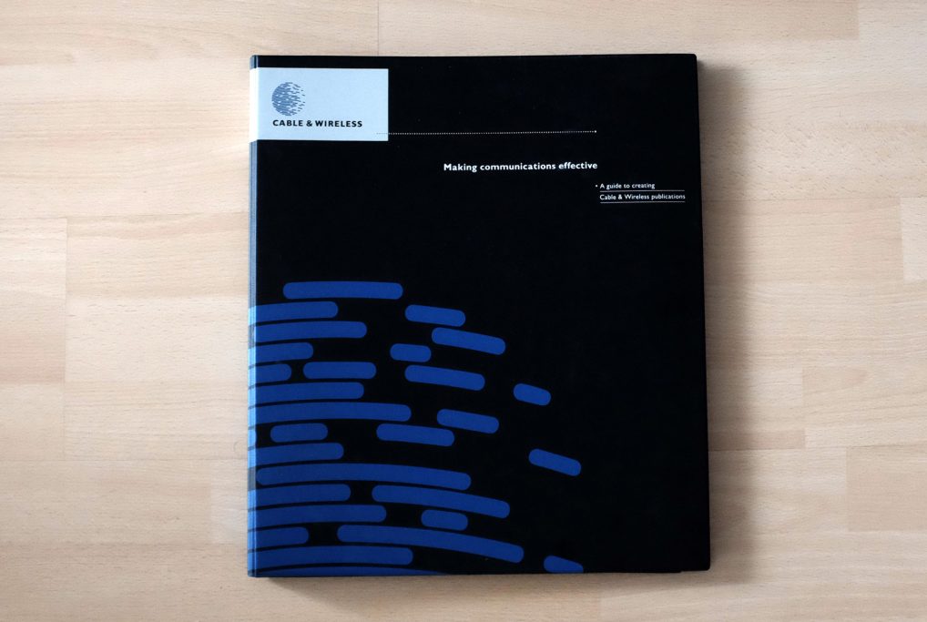 Black booklet with blue abstract lines and a white label in the top left corner.